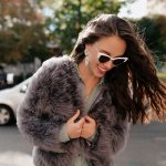 close-up-portrait-lovable-european-woman-glasses-looking-down-with-great-smile-min
