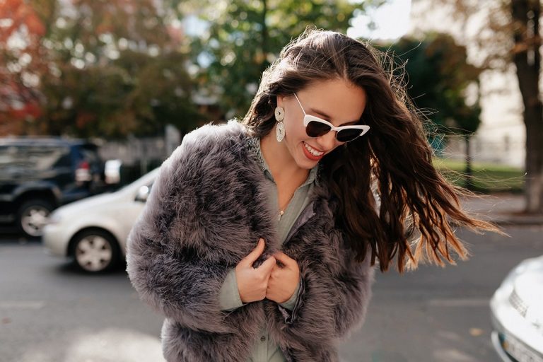 close-up-portrait-lovable-european-woman-glasses-looking-down-with-great-smile-min