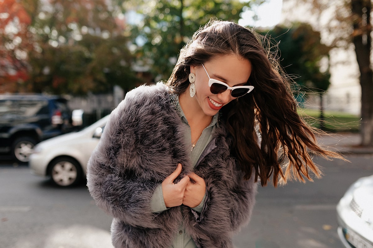 close-up-portrait-lovable-european-woman-glasses-looking-down-with-great-smile-min