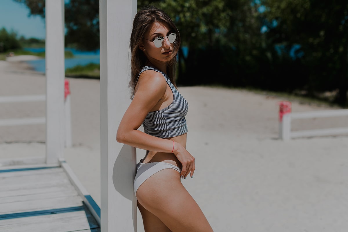 woman-swimwear-near-beach-pavilion-min